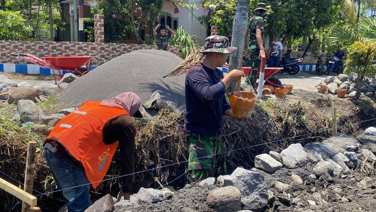 Anggota Satgas TNI Manunggal Membangun Desa (TMMD) ke-126 Kodim 0818/Malang-Batu dari Yon Armed 8/Udhata Yudha yang Pratu Firman bersama anggota lainnya terus mempercepat proses pengerjaan pembuatan drainase di Desa Lebakharjo, Kecamatan Ampelgading, Kabupaten Malang.